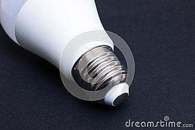 Fluorescent light bulb base on black background Stock Photo