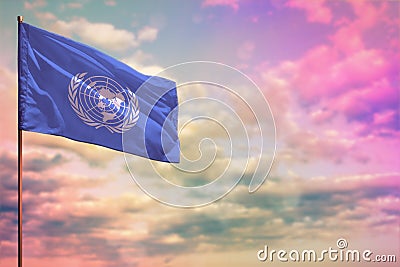 Fluttering United Nations flag mockup with the space for your content on colorful cloudy sky background Editorial Stock Photo