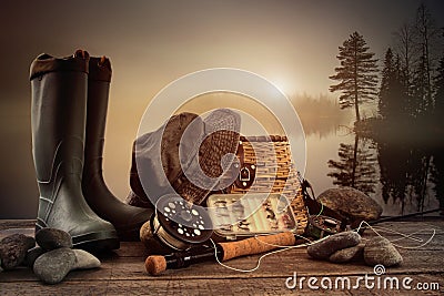 Fly fishing equipment on deck with misty lake Stock Photo