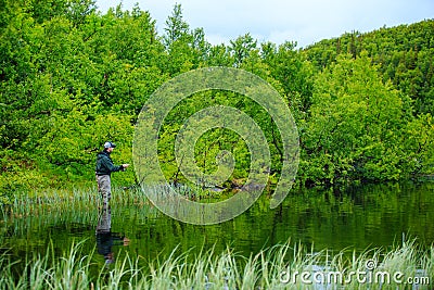 Fly fishing on the mountian lake Editorial Stock Photo