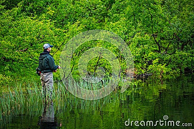 Fly fishing on the mountian lake Editorial Stock Photo