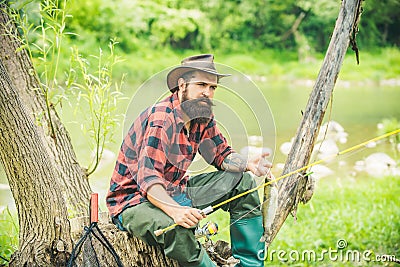 Fly fishing in the pristine wilderness of Canada. Happy fisherman fishing in river holding fishing rods. Stock Photo