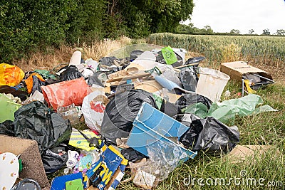 Fly tipping of household waste in a country lane. Hertfordshire. UK Editorial Stock Photo