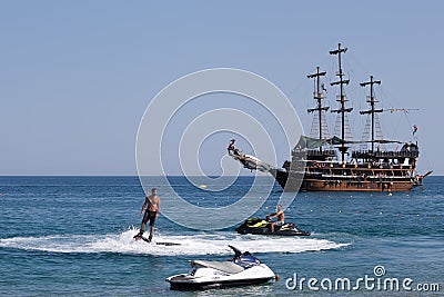 Flyboard and yachting stylized pirate schooner Editorial Stock Photo