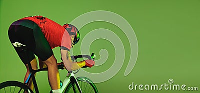 Flyer with young sportsman, cyclist on bicycle in sports uniform and protective helmet training isolated on green Stock Photo