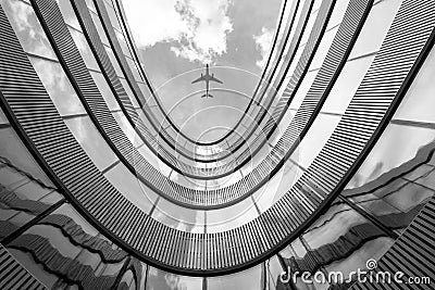 Flying airplane and modern architecture building Stock Photo