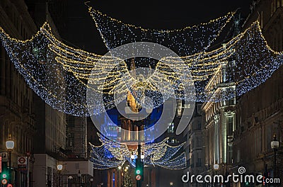 Flying angel Christmas decoration led lights display. Dramatic view of the traditional Christmas decoration lights hanging above Editorial Stock Photo