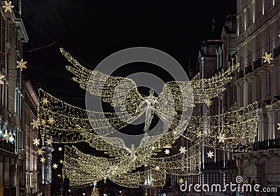 Flying angel Christmas decoration led lights display. Dramatic view of the traditional Christmas decoration lights hanging above Editorial Stock Photo