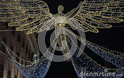 Flying angel Christmas decoration led lights display. Dramatic view of the traditional Christmas decoration lights hanging above Editorial Stock Photo