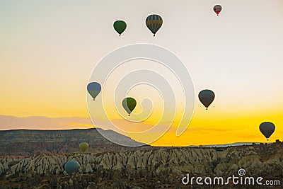 Flying on the balloons early morning in Cappadocia. Colorful spring sunrise in Red Rose valley, Goreme village location Editorial Stock Photo