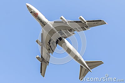 Flying Cargolux Boeing B747 airplane in underneck view with blue sky Editorial Stock Photo
