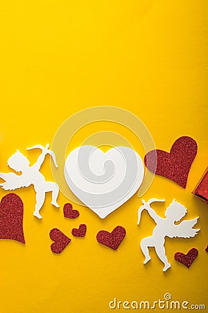 Flying cupid silhouette with hearts, happy Valentine`s Day banners, paper art style. Amour on yellow paper Stock Photo