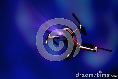 A flying drone. Airborne quadcopter. Also known as a drone or UAV, Unmanned Aerial Vehicle. Drone with camera. Stock Photo