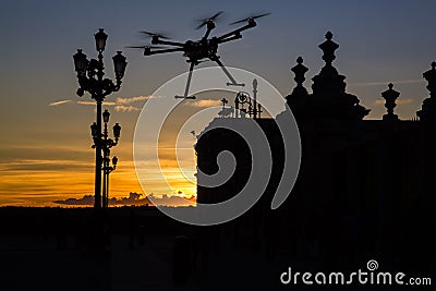 Flying drone in the sunset skies Stock Photo