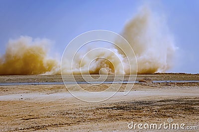 Flying dust after detonator blast in the desert Stock Photo