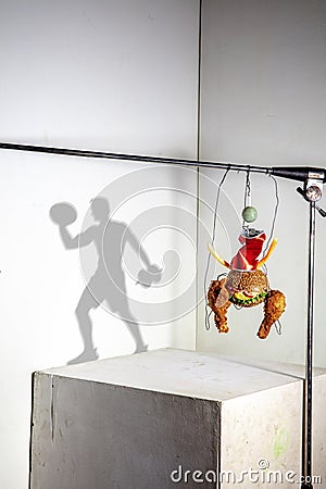 Flying food composition making beautiful sportsman drawing shadow on the wall Stock Photo