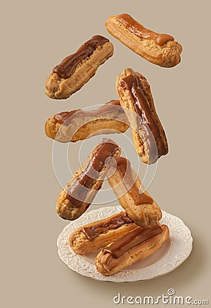 Flying eclairs with cocoa icing and condensed milk filling Stock Photo