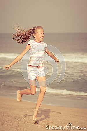 Flying jumping beach girl at blue sea shore Stock Photo