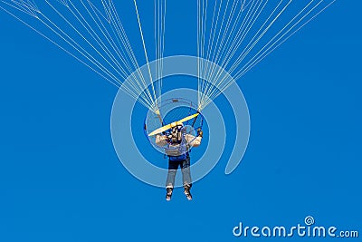 Flying motor paraglide in the blue sky Editorial Stock Photo