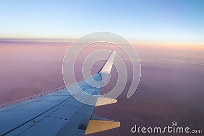 Flying over the clouds in evening Stock Photo