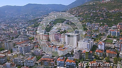 Flying over sunny town Alanya in Turkey located by the Mediterranean sea. Art. Aerial view of the mountain slope covered Stock Photo