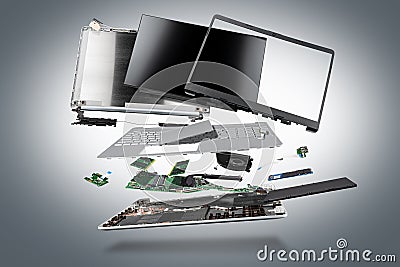 Flying parts of a notebook computer. hardware components mainboard cpu processor display RAM cables and cooling fan flying out of Stock Photo