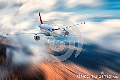 Flying passenger airplane and blurred background Stock Photo