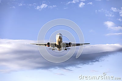 Flying passenger airplane preparing to land Stock Photo