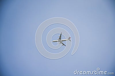 Flying passenger plane in blue sky Stock Photo