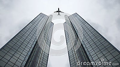 Flying passenger plane in the net on the background of a large modern building Stock Photo