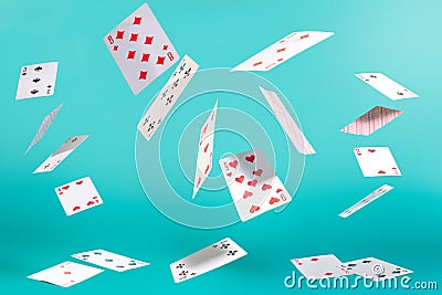 Flying playing cards on a turquoise background Stock Photo