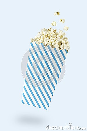 Flying popcorn with blue-touched packet Stock Photo