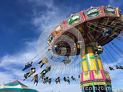 Flying swing carnival rides at a local street fair Editorial Stock Photo