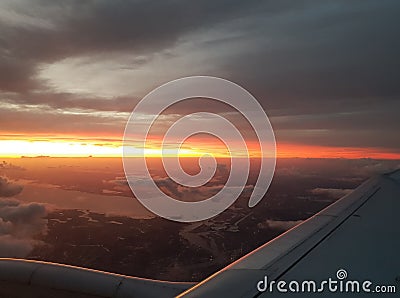 Flying to the sun view airplane window Stock Photo