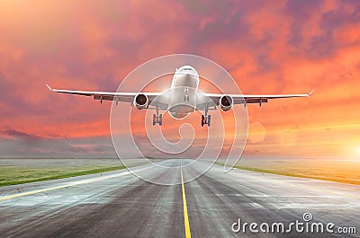 Flying and traveling, sunset airplane landing runway airport. Stock Photo