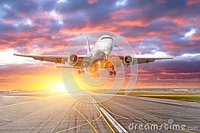 Flying and traveling, sunset airplane landing runway airport. Stock Photo