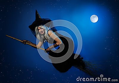 Flying witch with a broom Stock Photo