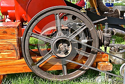 Flywheel of an old engine transfers energy by use of a v belt Stock Photo