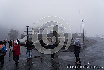 The FlÃ¸ien Folkerestaurant restaurant on a wet and rainy day with tourists. Bergen Norway Editorial Stock Photo