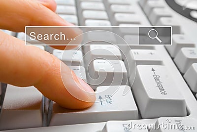 Fnger presses the computer key Enter with search bar Stock Photo