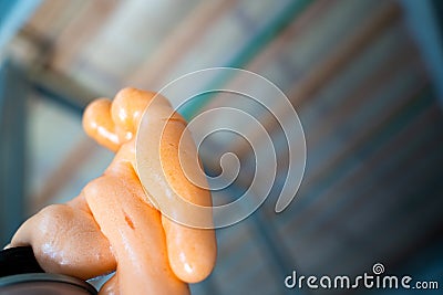 Foamed building mounting foam orange color close-up against the background of the insulated ceiling Stock Photo