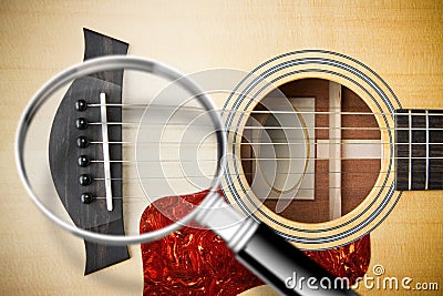 Focus on the acoustic guitar wooden bridge - concept with image seen through a magnifying glass Stock Photo
