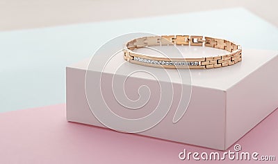 Focus on diamonds on golden bracelet on pastel colors background with copy space Stock Photo