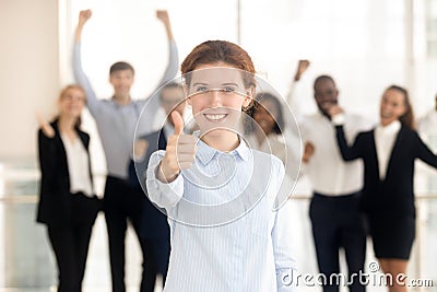 Client showing thumbs up satisfied with service employees on background Stock Photo