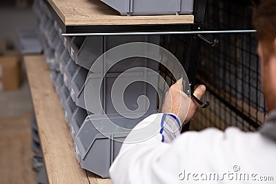 Focus on the hand of a male master worker mounting a shelf. Copy space Stock Photo