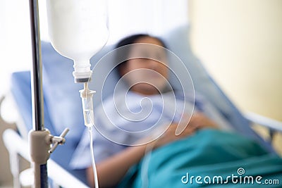 Focus intravenous drop saline drip in hospital and blurry background Stock Photo