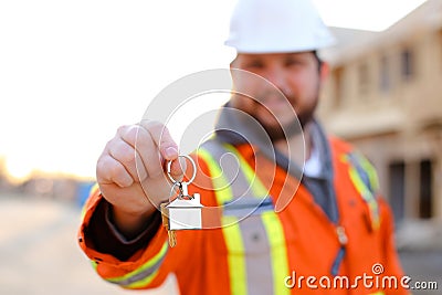 Focus on keys in foreman hands on construction site. Stock Photo