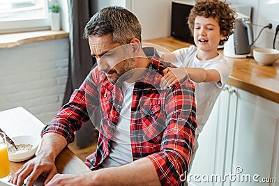 Focus of kid touching displeased father Stock Photo