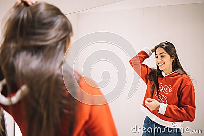 On focus mirror reflection of woman with Christmas blouse Stock Photo