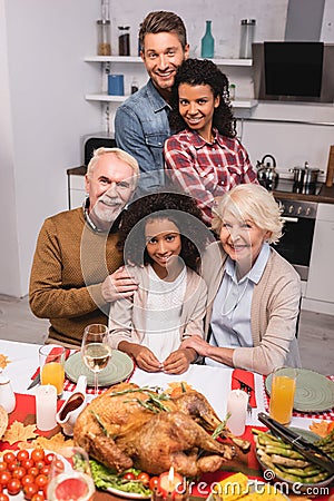 Focus of multicultural family hugging near Stock Photo